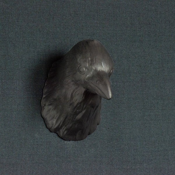 Figurative ceramic sculpture of a Raven