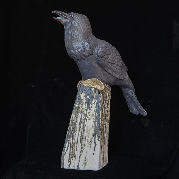 Figurative ceramic sculpture of a Raven