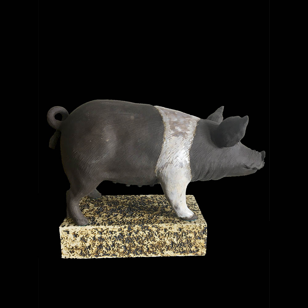 Figurative ceramic sculpture a black and white pig